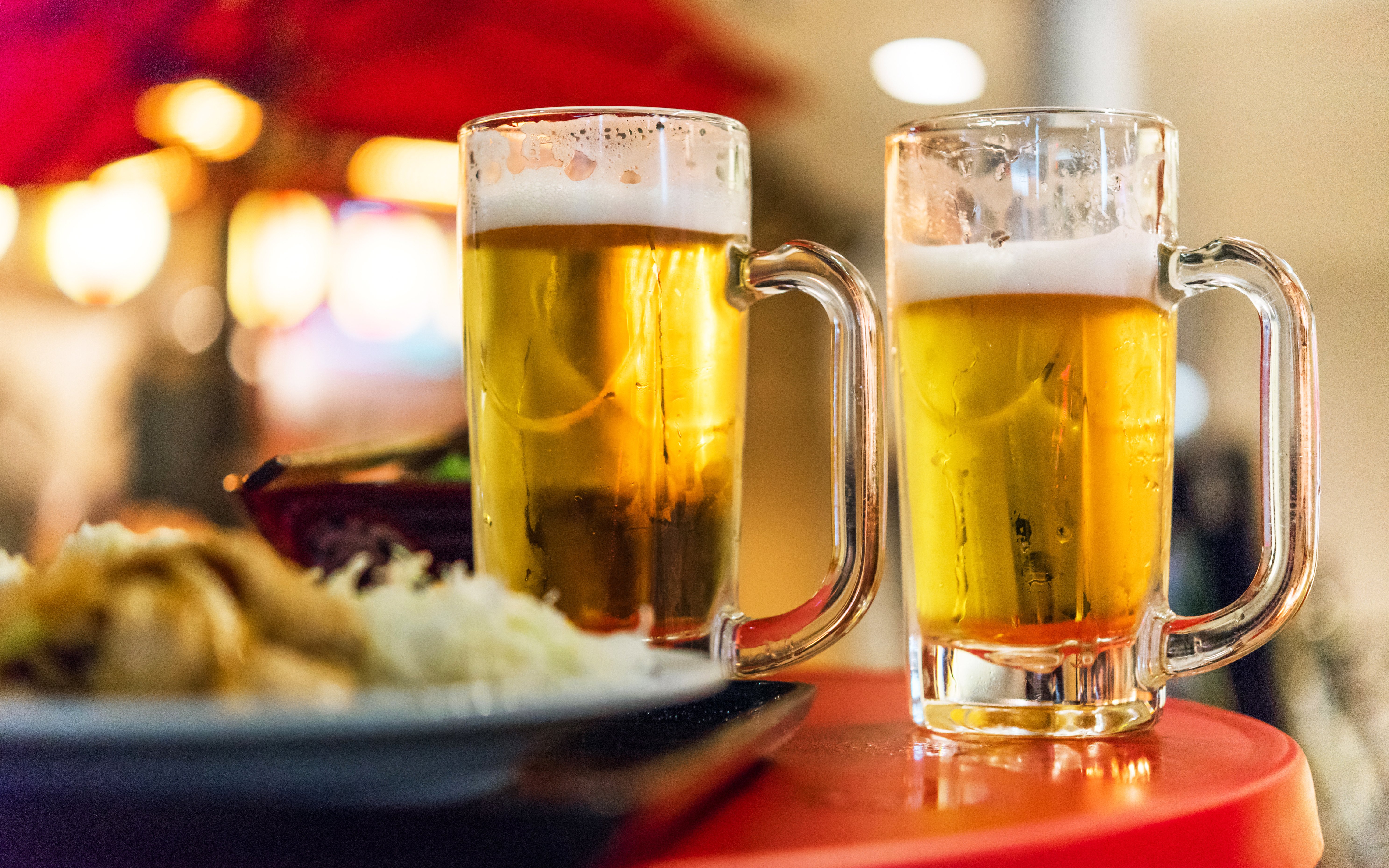 Two beer glasses on a table in Tokyo, Japan, close-up.