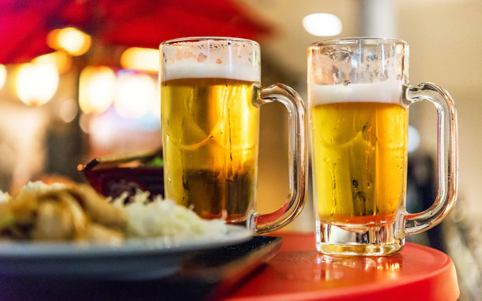 Two beer glasses on a table in Tokyo, Japan, close-up.