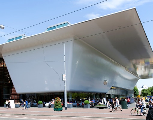 Stedelijk Museum Amsterdam modern art exhibit with visitors exploring galleries.