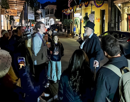 Guided tour group exploring haunted sites in New Orleans, featuring ghost, voodoo, and vampire stories.
