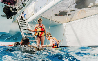 People enjoying a swim from a boat during a mini cruise to Papagayo Beaches, Lanzarote.
