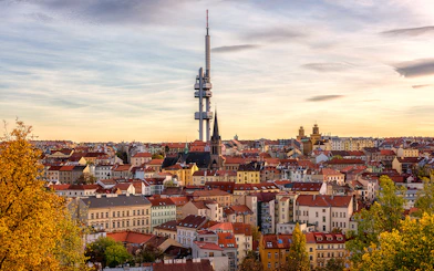 Prague skyline with Žižkov Television Tower and historic buildings.