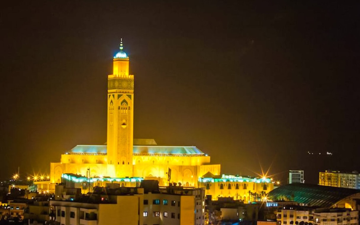 Hassan II Mosque illuminated at night in Casablanca, Morocco.