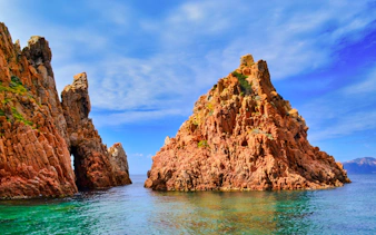 Frioul Archipelago rocky cliffs with clear blue sea and sky.