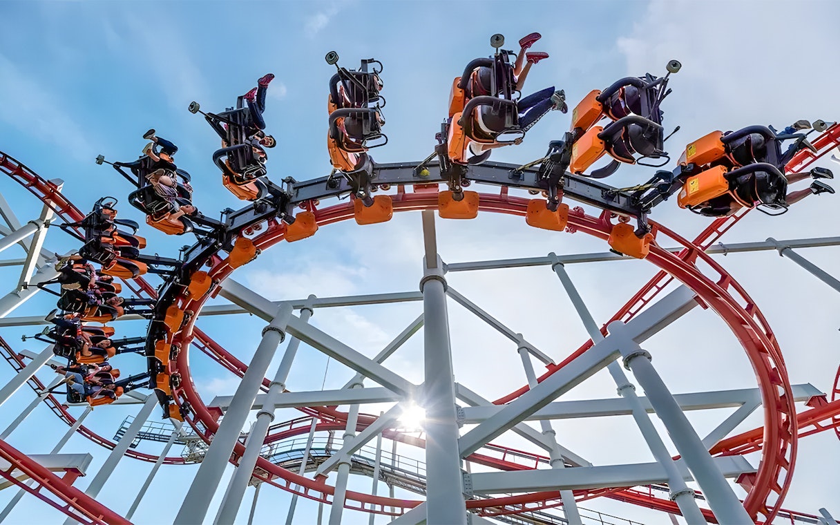 Roller coaster loop at Dream World Bangkok with riders upside down.
