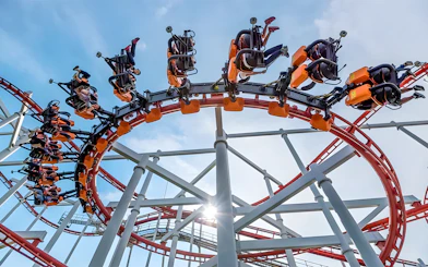 Roller coaster loop at Dream World Bangkok with riders upside down.