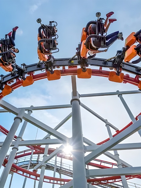 Roller coaster loop at Dream World Bangkok with riders upside down.