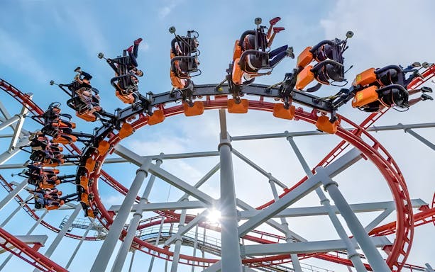 Roller coaster loop at Dream World Bangkok with riders upside down.