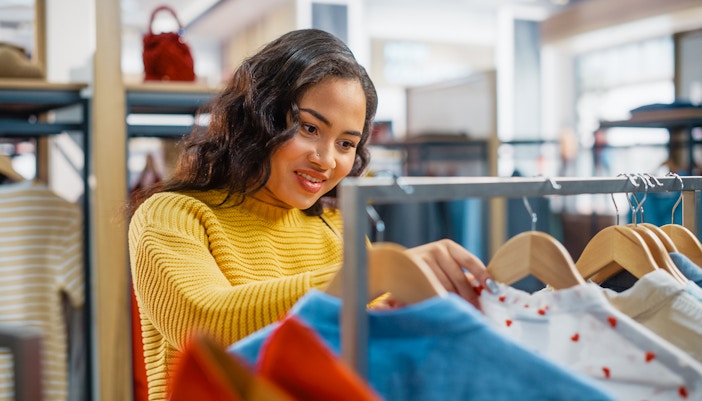 Woman shopping clothes in a clothing store