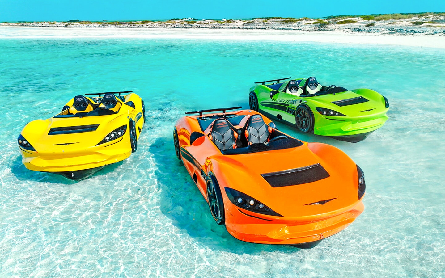Three colorful Jet cars floating on clear water at Dubai shore.