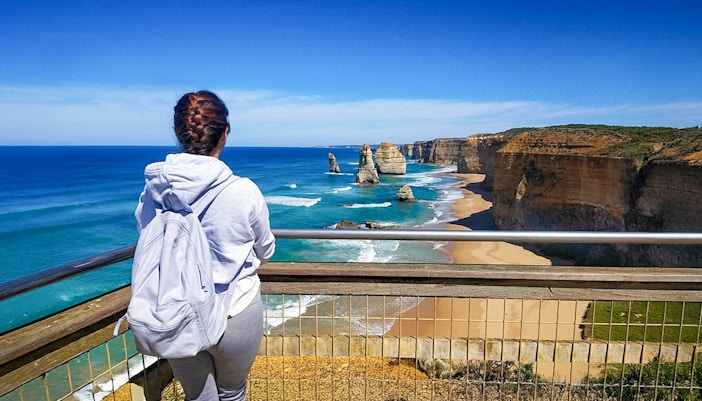 Lady admiring 12 Apostles from viewpoint along Great Ocean Road, Melbourne.