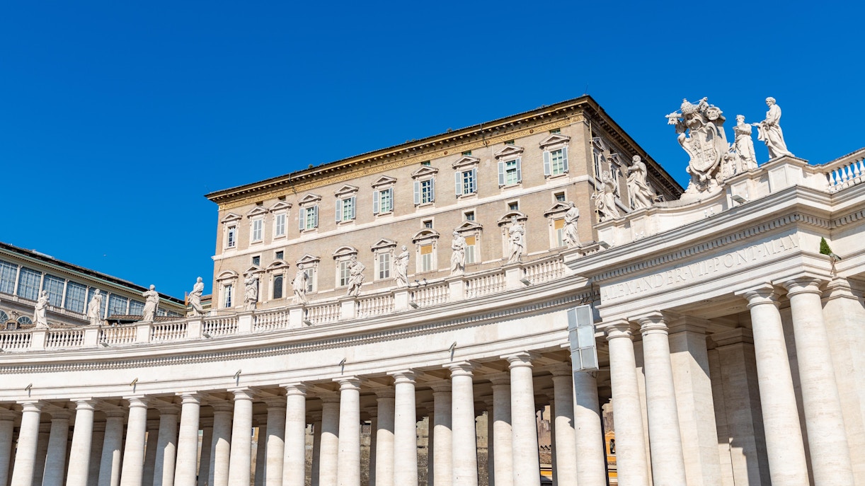 Apostolic Palace facade with statues and columns in Vatican City.