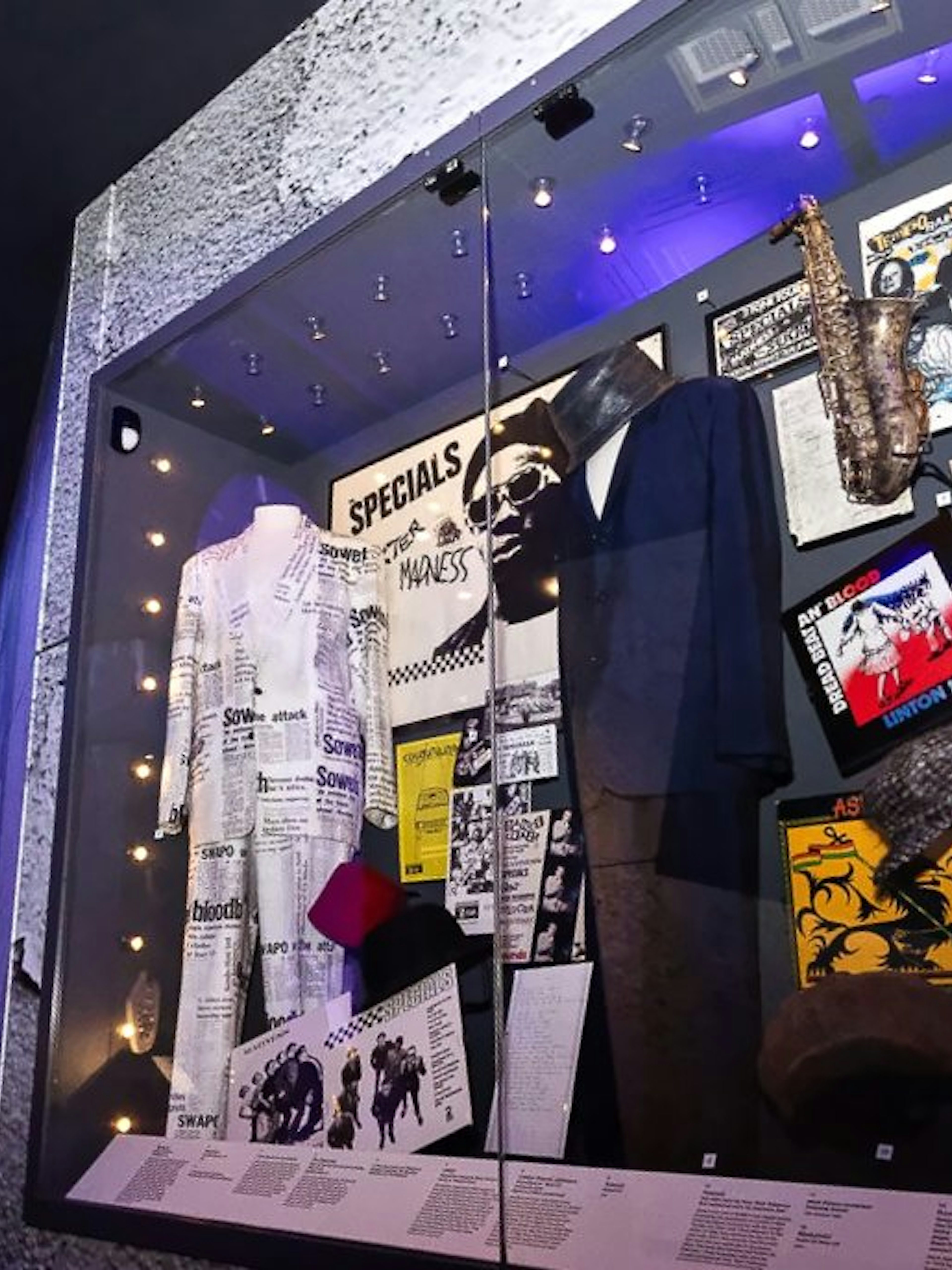 Exhibit of British music memorabilia including instruments and costumes at The British Music Experience.