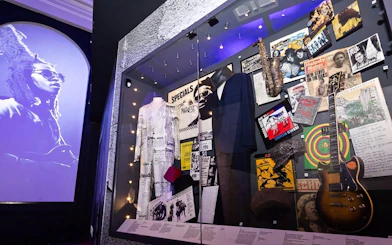Exhibit of British music memorabilia including instruments and costumes at The British Music Experience.