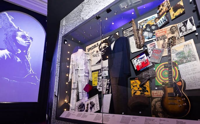 Exhibit of British music memorabilia including instruments and costumes at The British Music Experience.