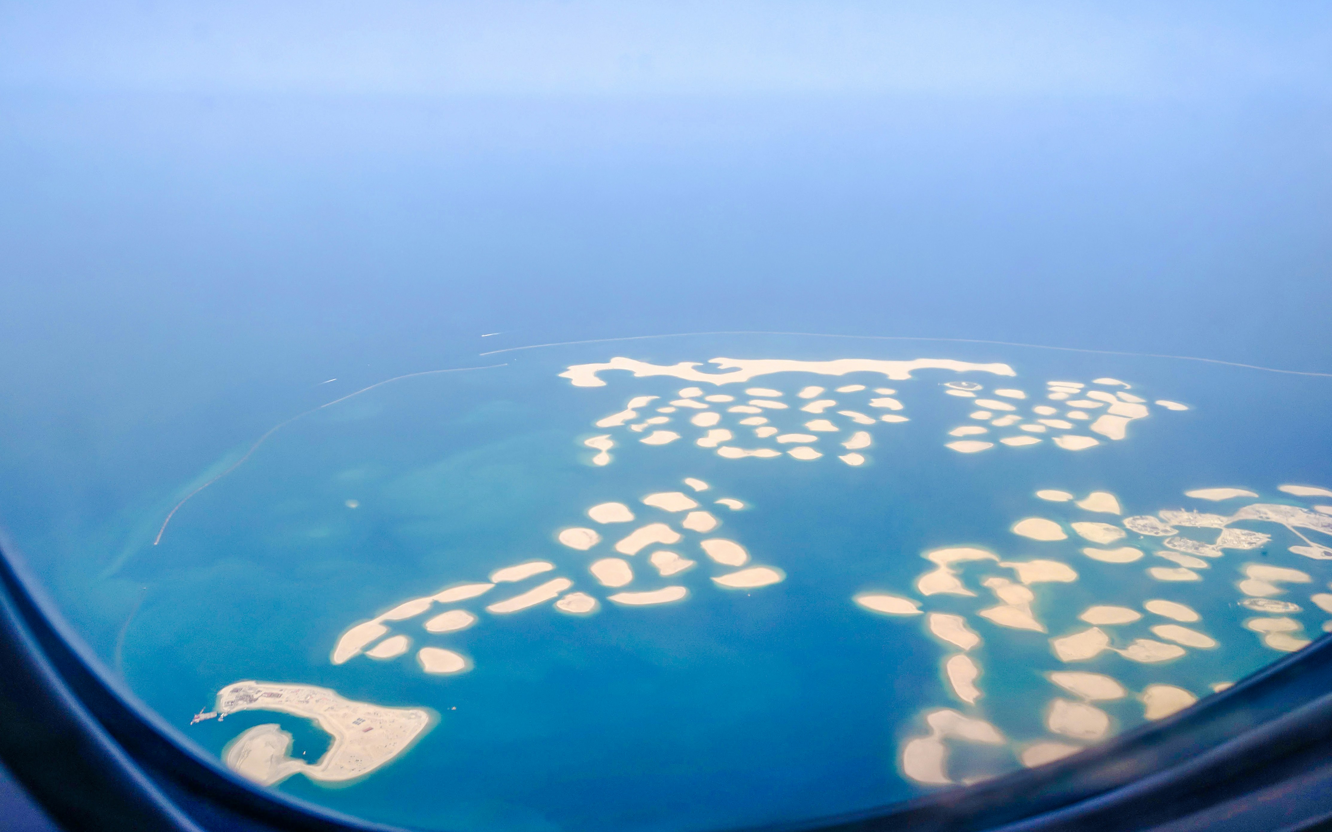 Aerial view of The World Islands in Dubai, United Arab Emirates, seen from an airplane.