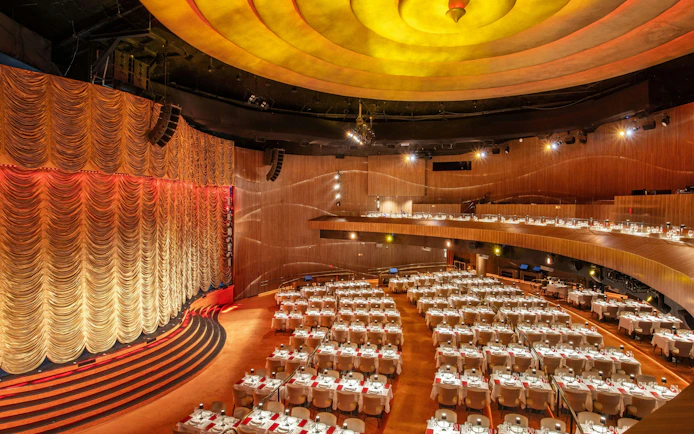 Dinner show venue with stage and seating at Roxy in Rio de Janeiro.