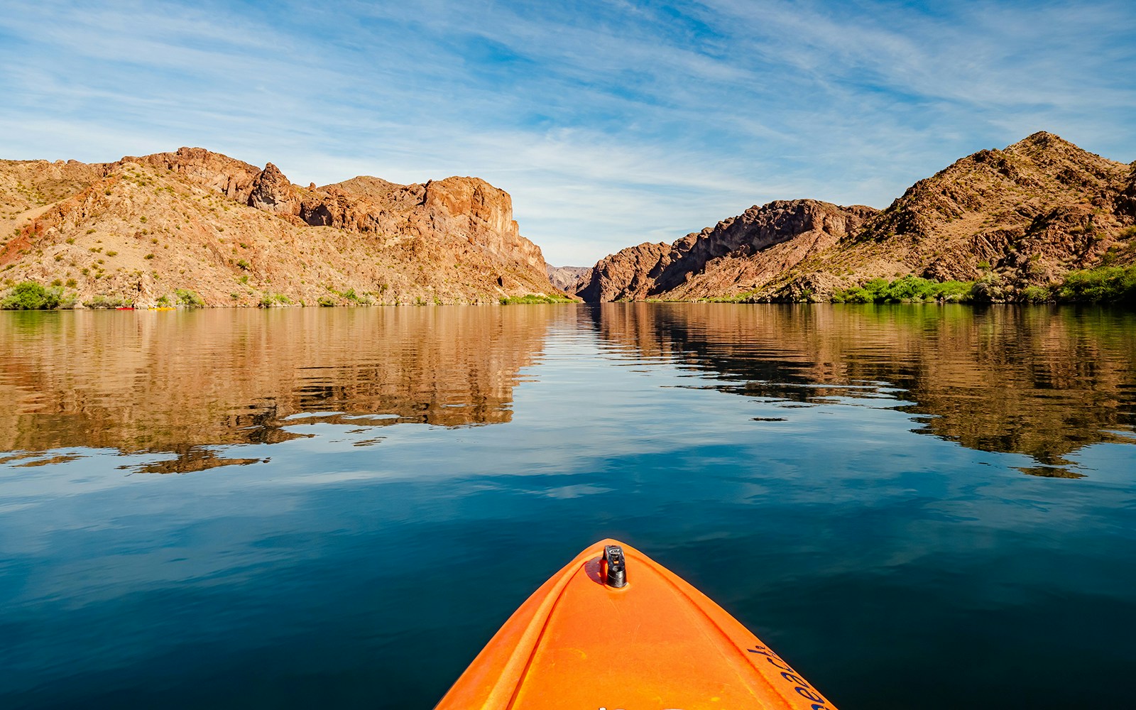 Kayaking on Lake Mead with view of rocky desert landscape.