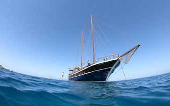 Sailing boat on the water during a cruise at Fernandes Gozo & Comino, Malta.