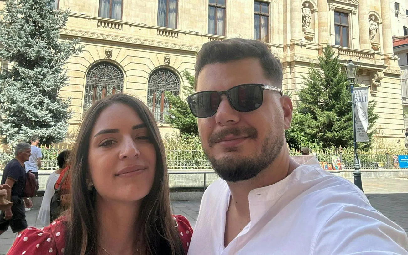 Couple exploring historic architecture in Bucharest during self-guided city game.