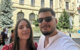 Couple exploring historic architecture in Bucharest during self-guided city game.