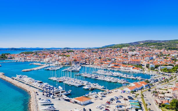 Aerial view of Vodice marina and turquoise Adriatic coastline, Croatia.