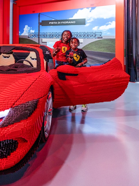 Ferrari GTS Lego model with children at Build and Race Test Zone, LEGOLAND Florida.