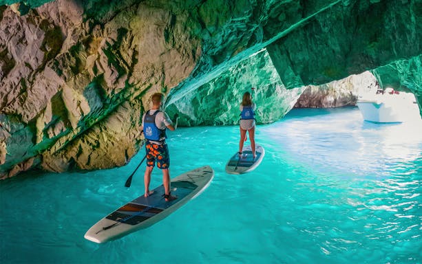Stand-up paddleboarding inside a cave in Capri, Italy.