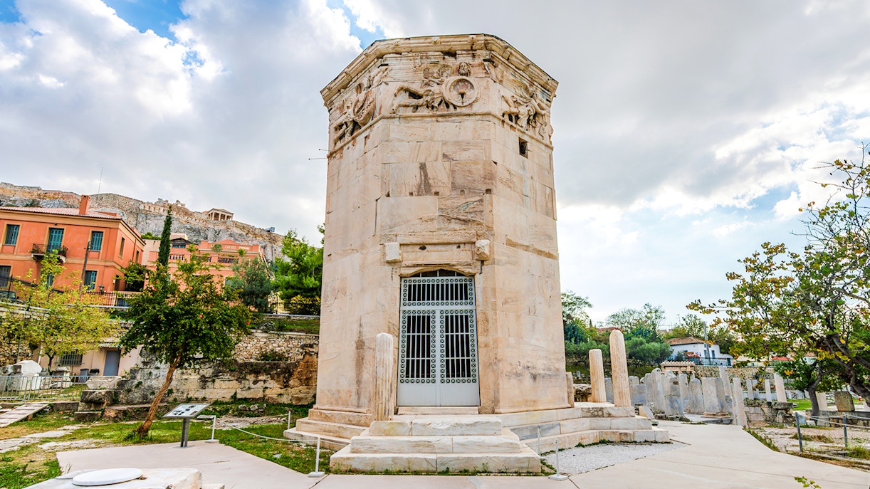 Tower of the Winds in the Ancient Roman Forum, Athens, with Acropolis in the background.