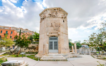 Tower of the Winds in the Ancient Roman Forum, Athens, with Acropolis in the background.