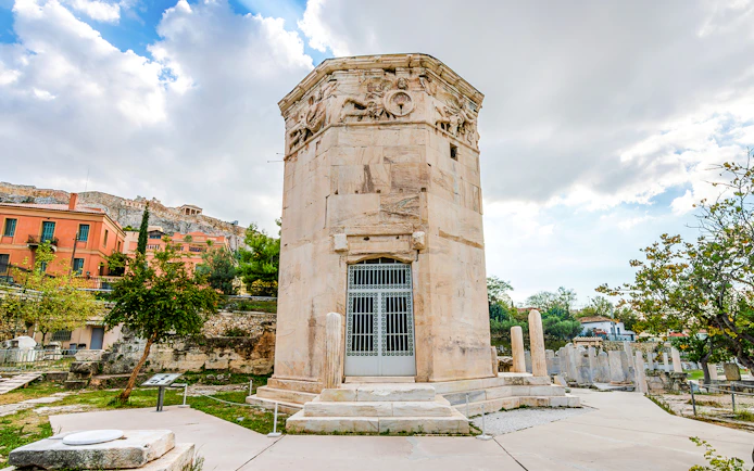 Tower of the Winds in the Ancient Roman Forum, Athens, with Acropolis in the background.