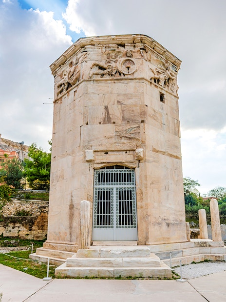 Tower of the Winds in the Ancient Roman Forum, Athens, with Acropolis in the background.