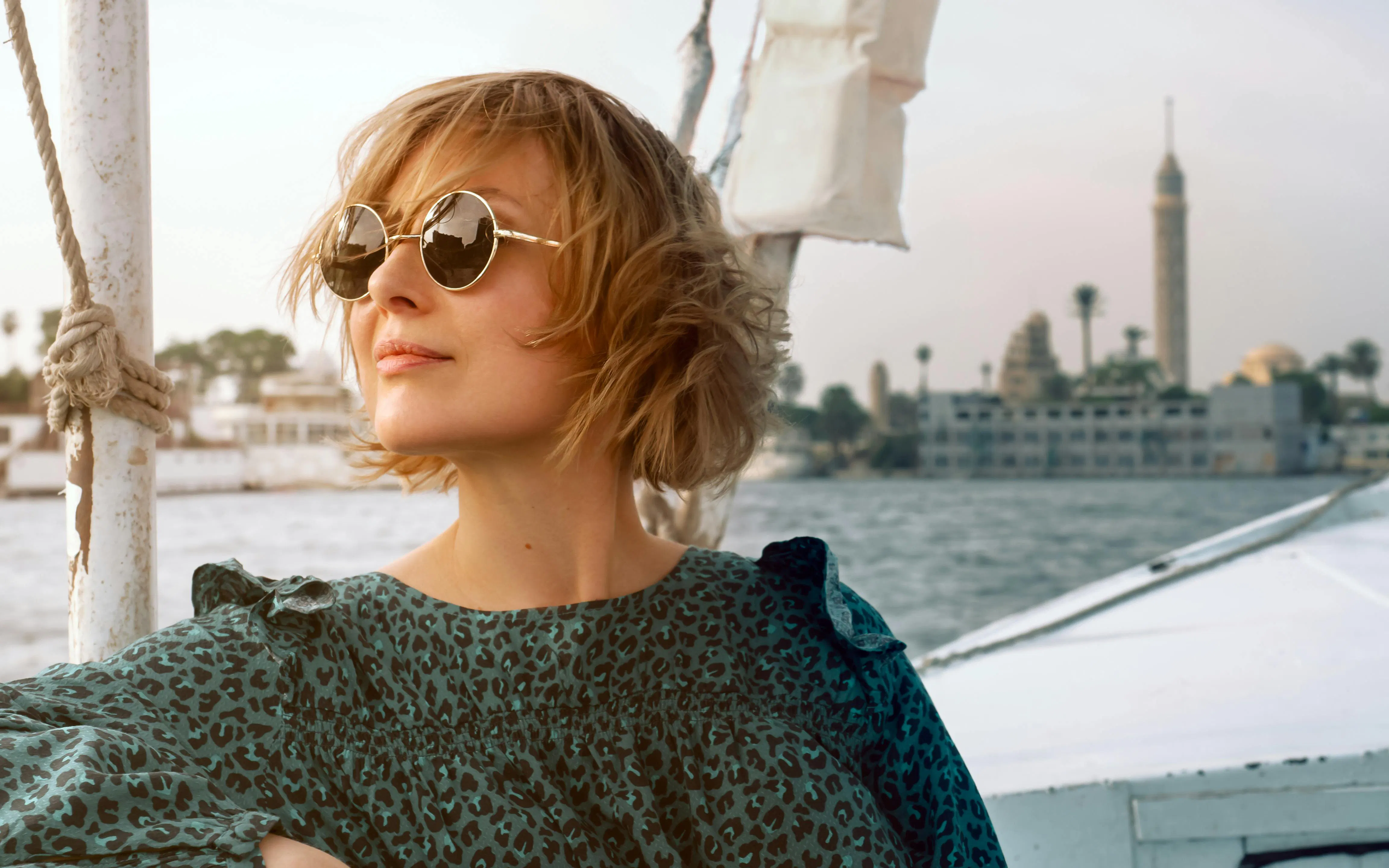 Woman in a boat on the Nile River with Cairo Tower in the background, Cairo, Egypt.