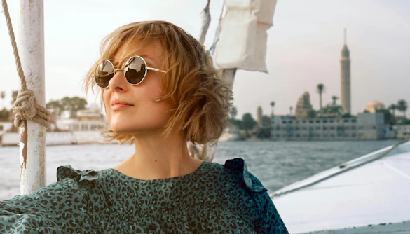 Woman in a boat on the Nile River with Cairo Tower in the background, Cairo, Egypt.