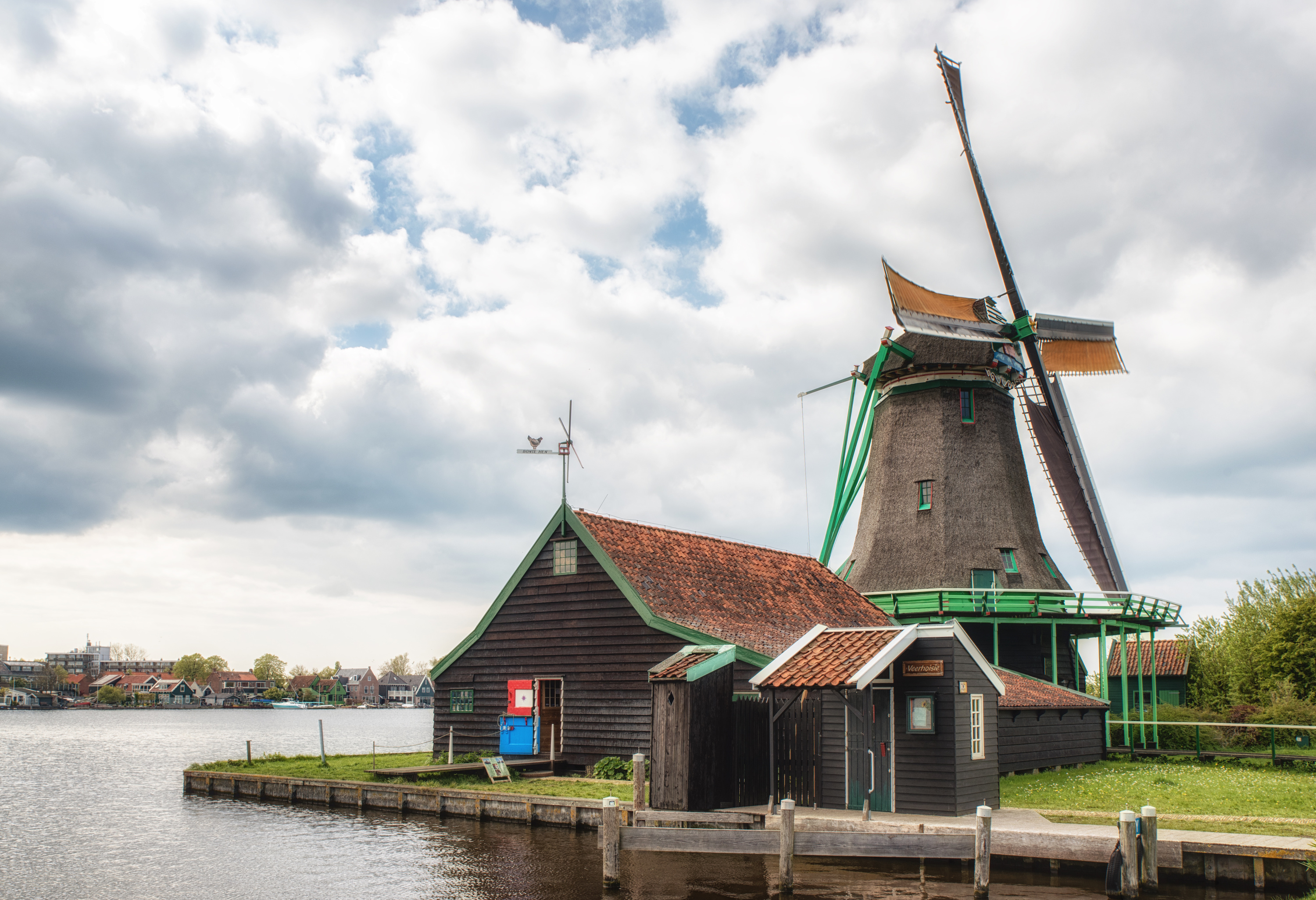 Windmill and traditional buildings at De Zaanse Schans, Netherlands.