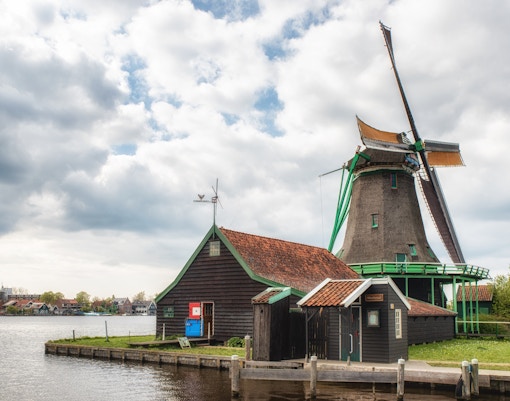 Windmill and traditional buildings at De Zaanse Schans, Netherlands.