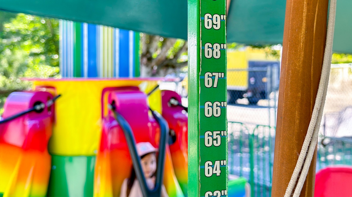 Height ruler at ride entrance, establishing height requirements for attraction access.