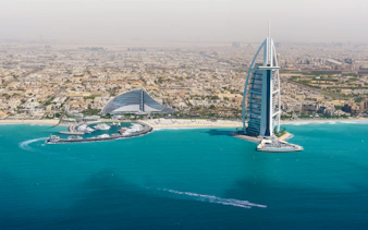 Dubai skyline with Burj Al Arab and coastline from helicopter view.