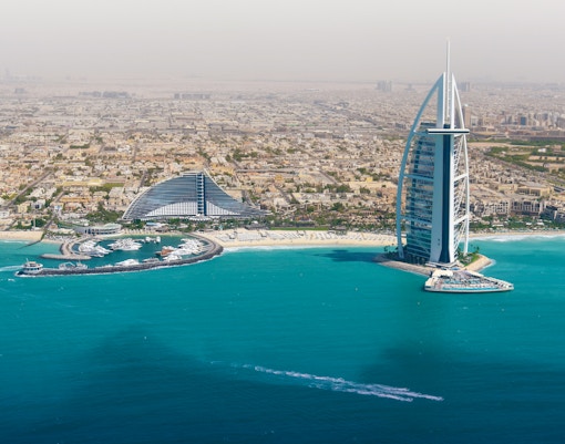 Dubai skyline with Burj Al Arab and coastline from helicopter view.