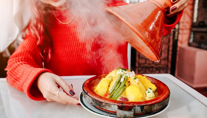Tagine dish being served at Jema el Fna street food market in Marrakesh.