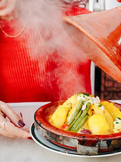 Tagine dish being served at Jema el Fna street food market in Marrakesh.
