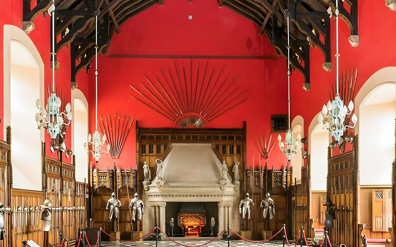 The Great Hall at Edinburgh Castle showcasing historical weaponry and suits of armor.