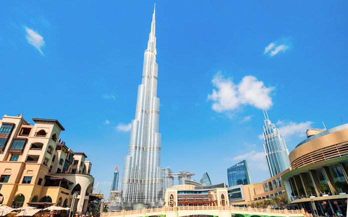 Burj Khalifa towering over Dubai cityscape on a clear day.