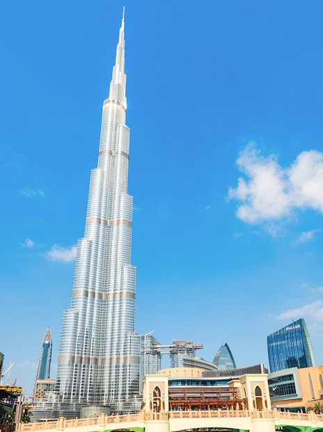 Burj Khalifa towering over Dubai cityscape on a clear day.