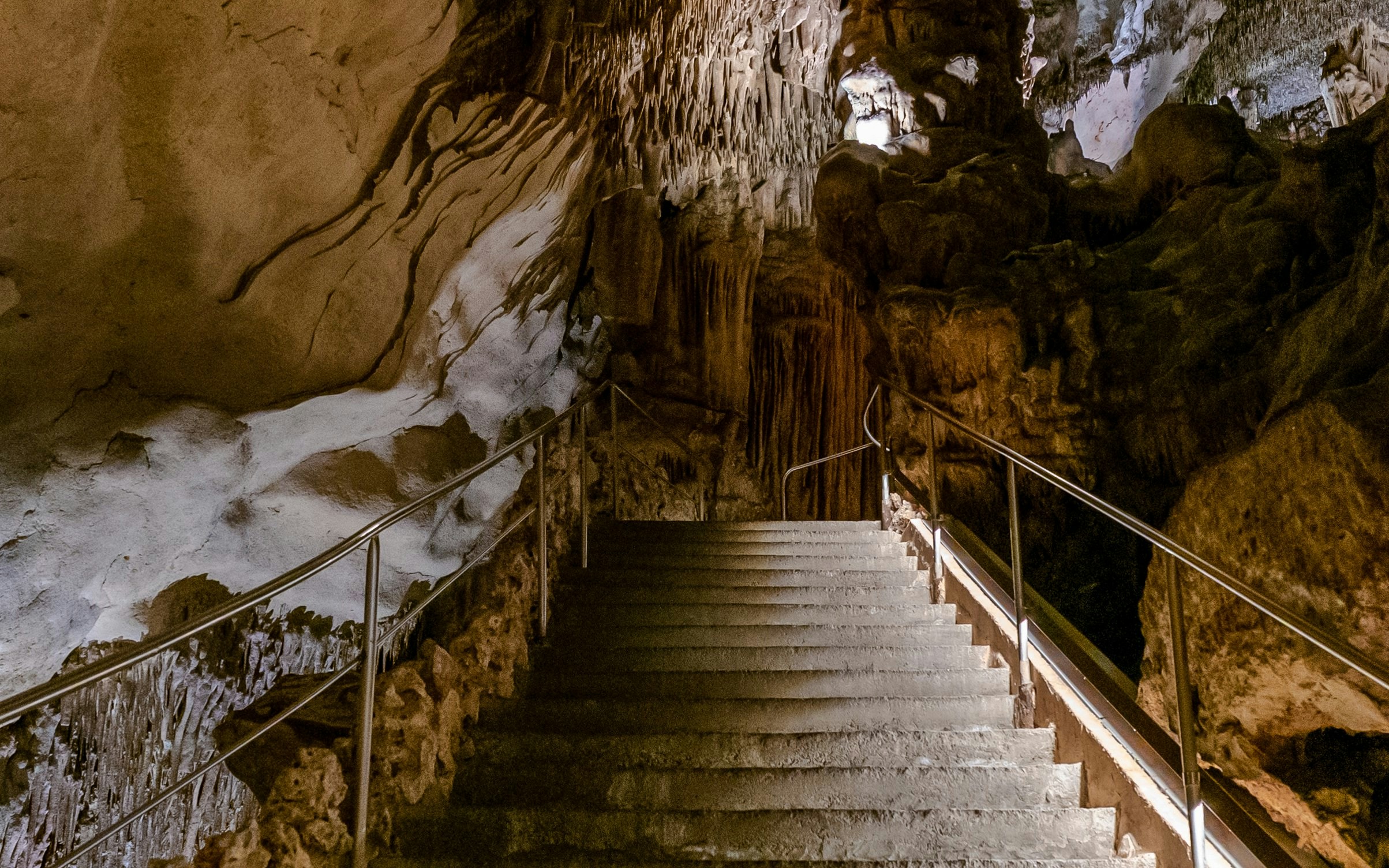 Stairs leading to exit in Drach Caves, Porto Cristo, surrounded by stalactites.