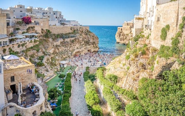 Lama Monachile beach with cliffs and sea view in Polignano a Mare, Italy.