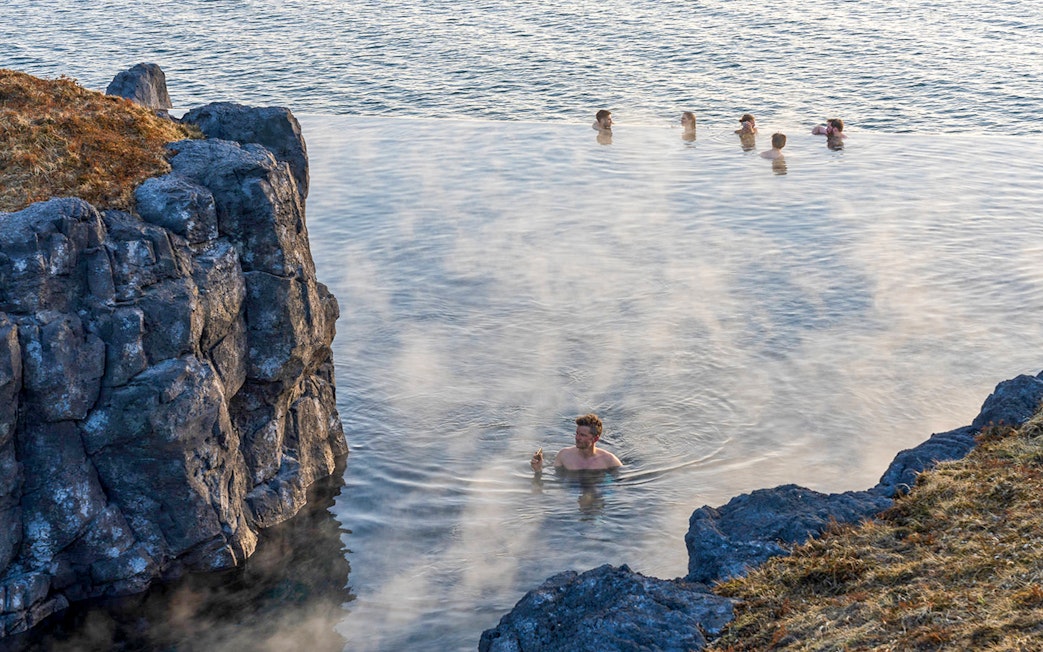 Guests relaxing in geothermal waters at Sky Lagoon, Reykjavik.