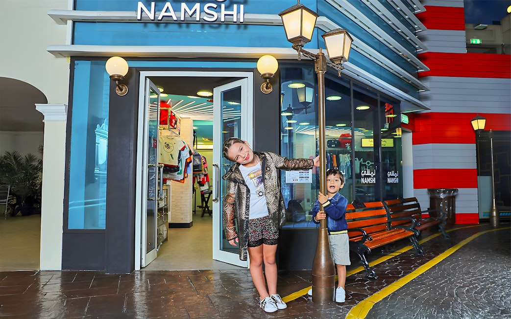 Children playing outside Namshi store at Fashion Street, Kidzania, Abu Dhabi.