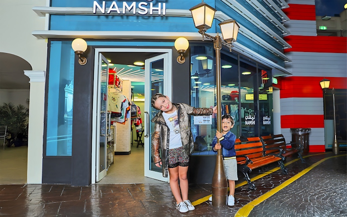 Children playing outside Namshi store at Fashion Street, Kidzania, Abu Dhabi.