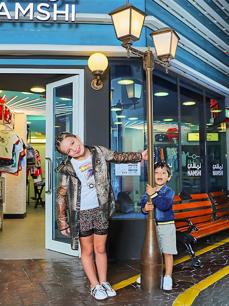 Children playing outside Namshi store at Fashion Street, Kidzania, Abu Dhabi.